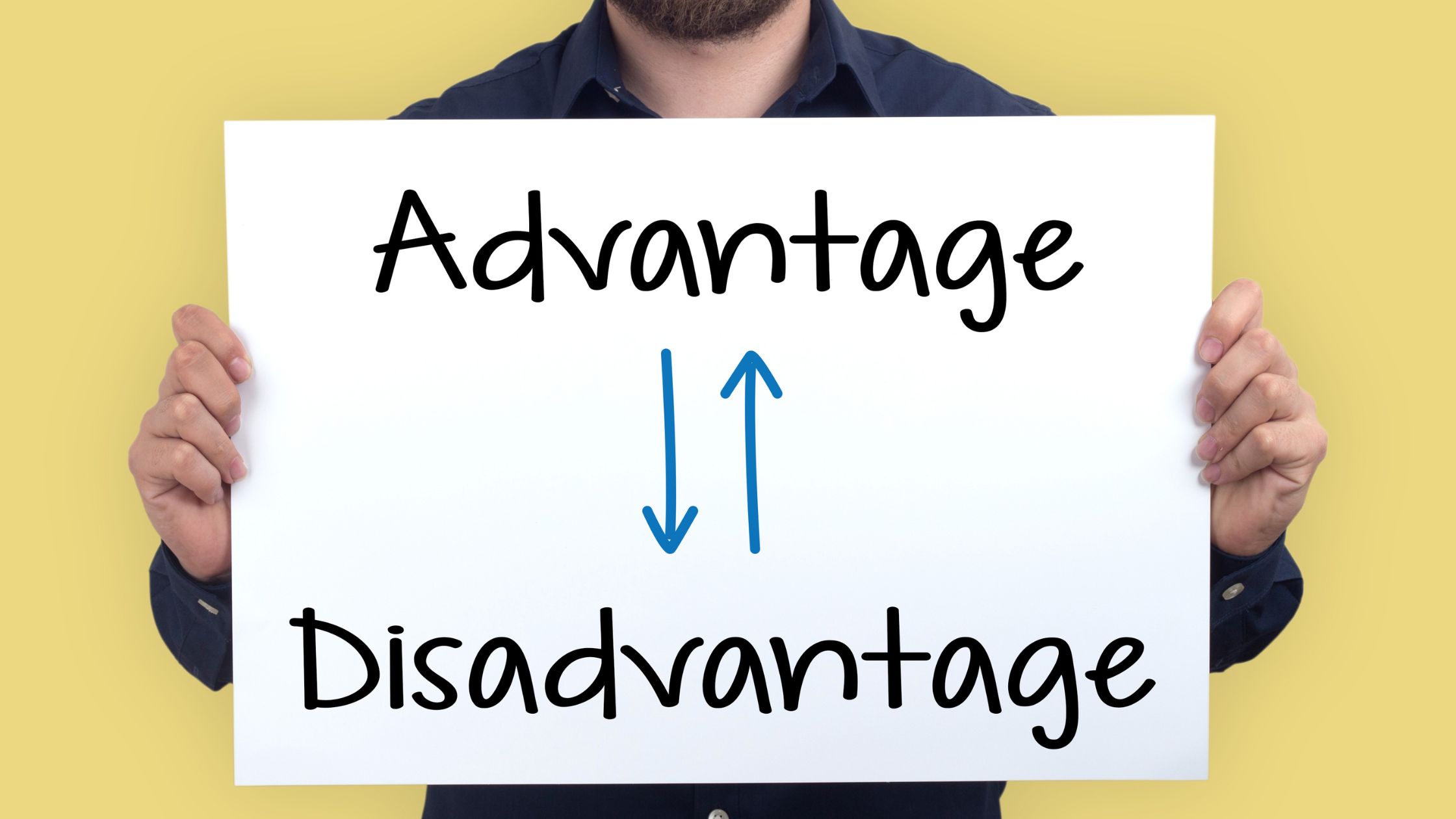 person holding sign saying advantages and disadvantages