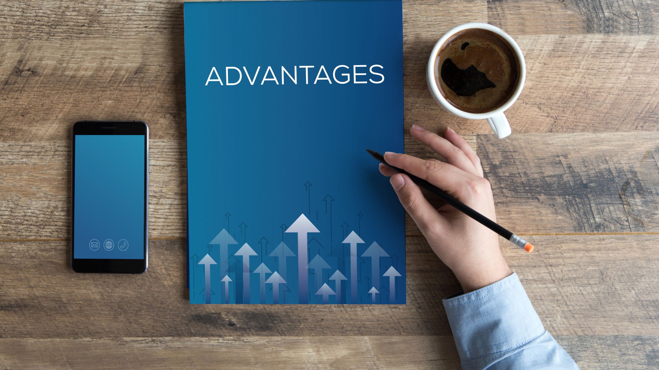 book labeled advantages next to coffee cup and phone