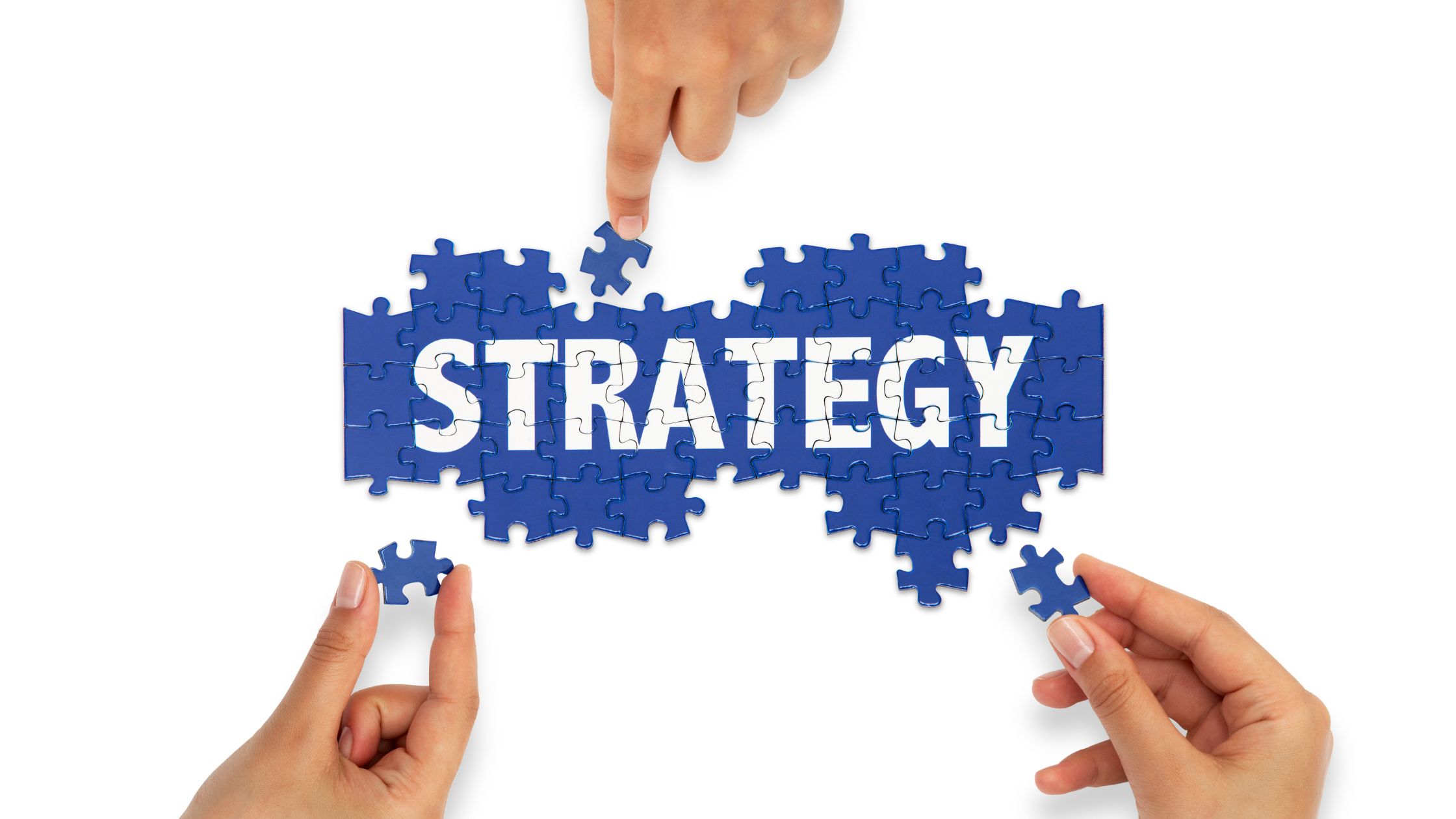 blue puzzle pieces that spell out strategy