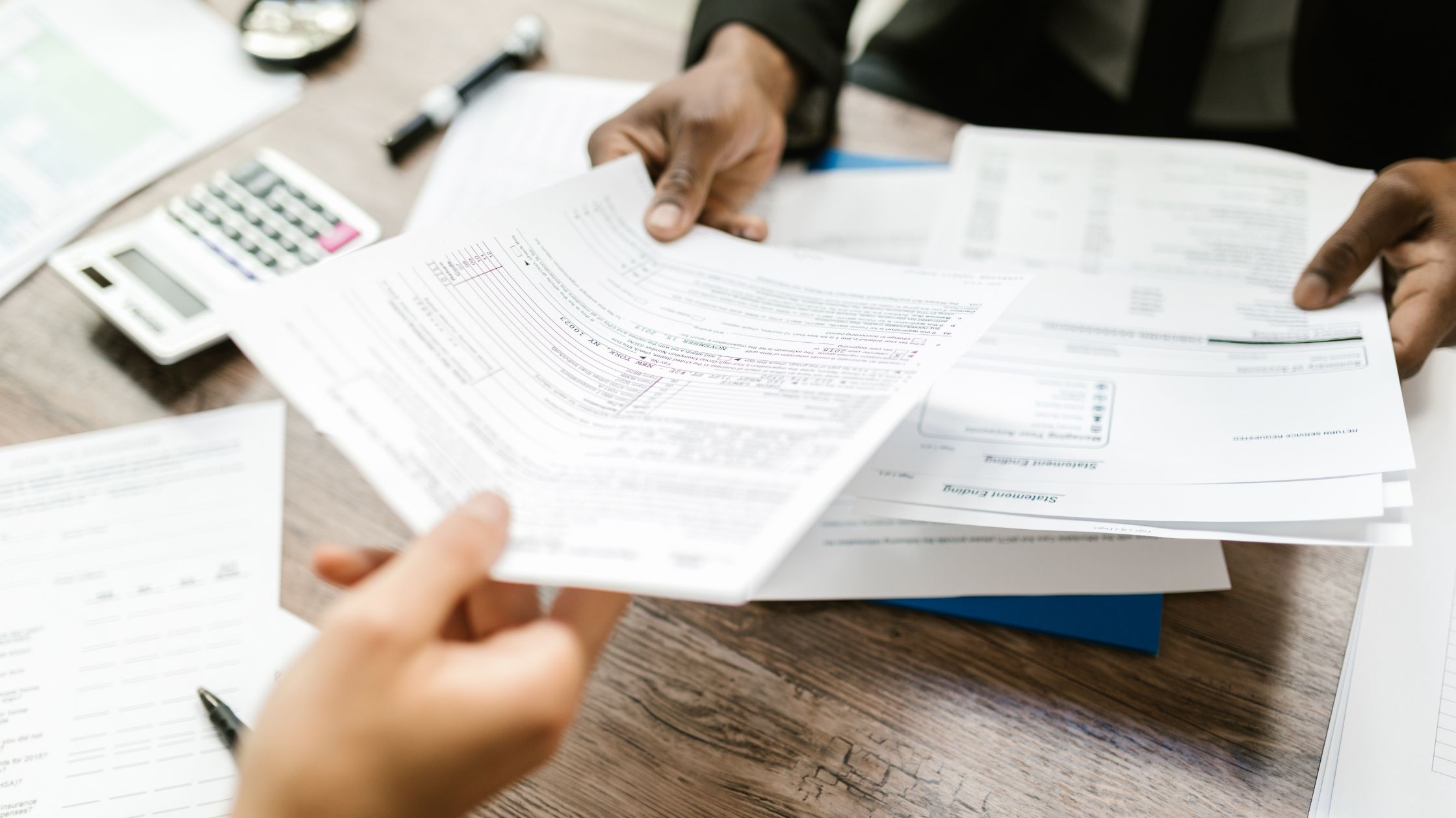 interest paperwork in hand of woman and shown to customer