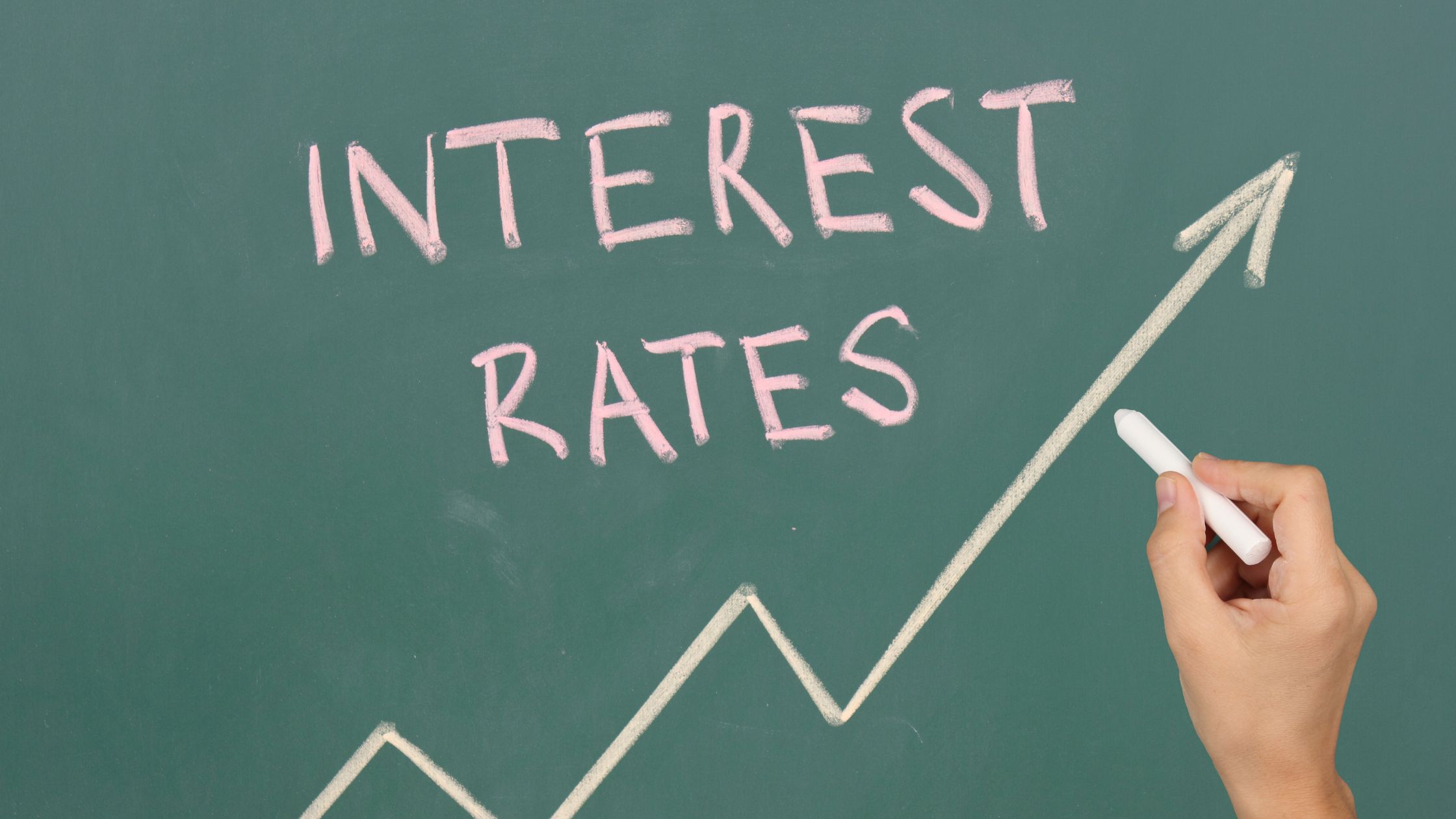 chalkboard with graph going up and high interest rates written in chalk