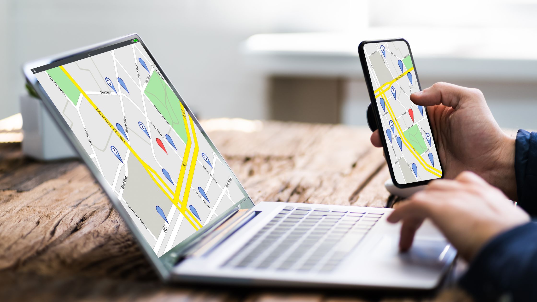 person searching on computer and phone