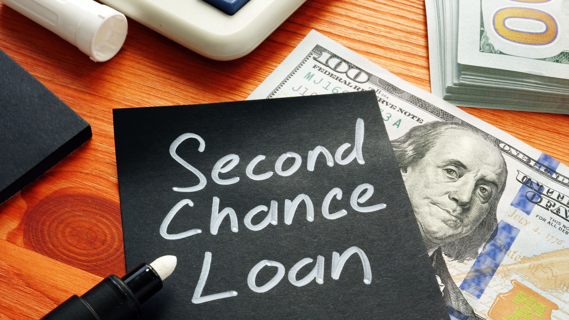 black sticky note with second chance loan written in white