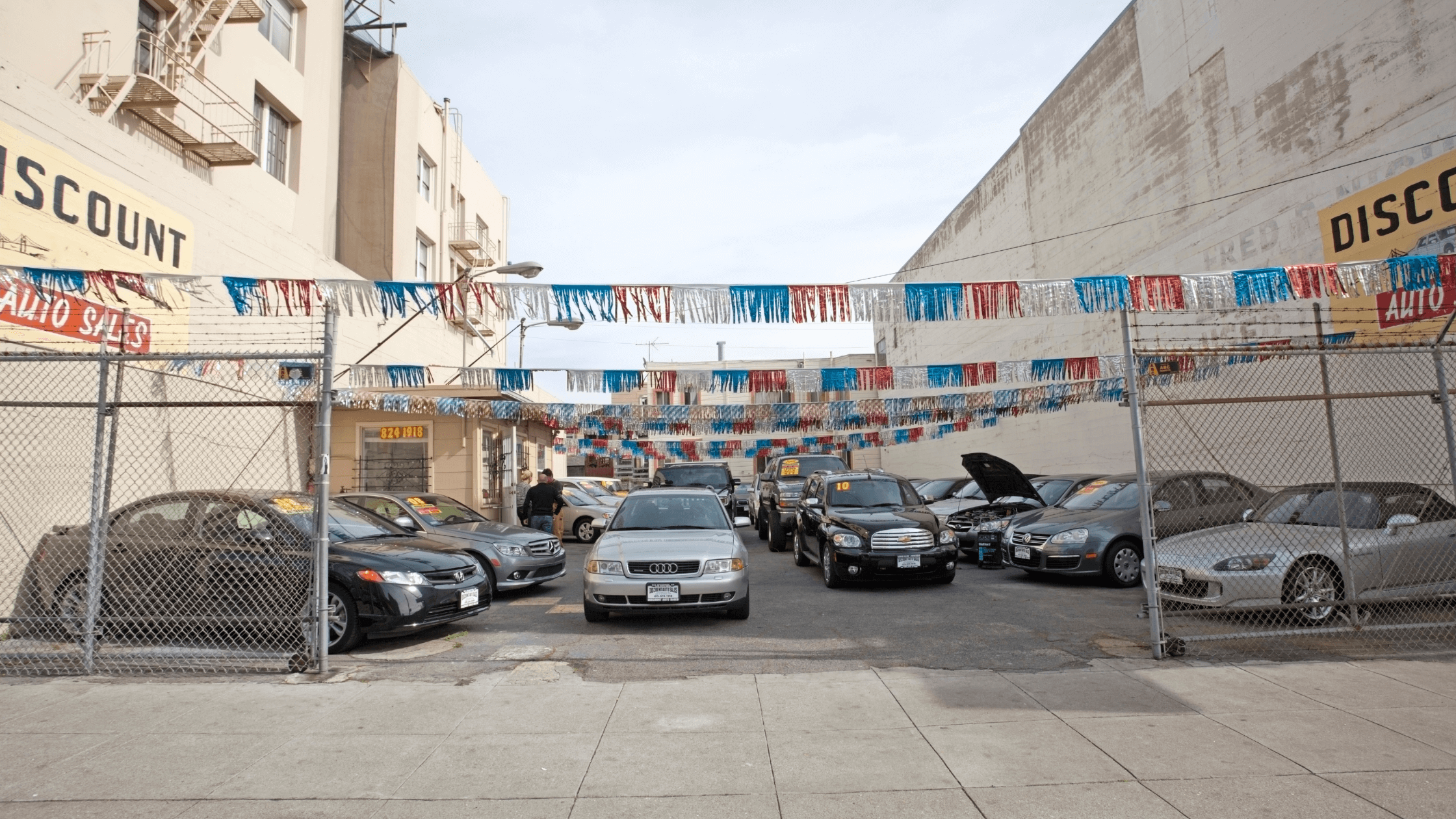 used car lot in between buildings